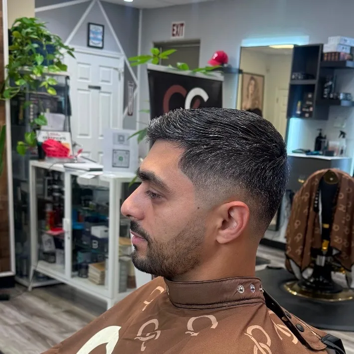 Clean comb-over taper with a full beard